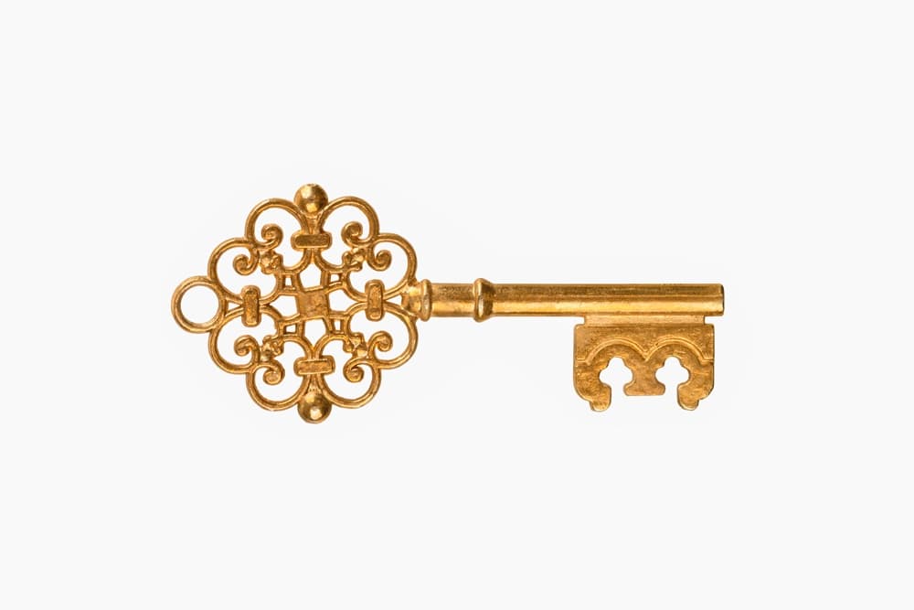 A decorative gold key with an ornate design.
