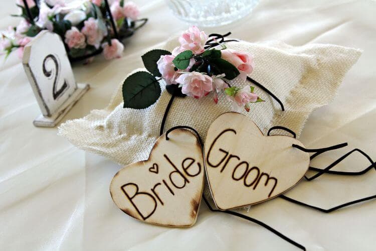 wooden bride and groom hearts with ring bearer pillow
